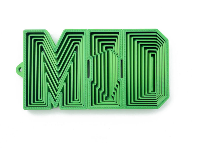 MID word fidget in green, laid-back 3D-printed flexible design with nested lettering